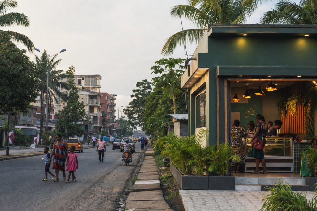 A modern neighbourhood food shop on a lively street in Makepe, Douala